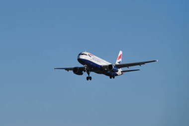 Lisbon, Portugal - September 2, 2023: British Airways Airbus A320-232 passenger plane descends for landing in blue sky in Humberto Delgado Airport in Lisbon clipart