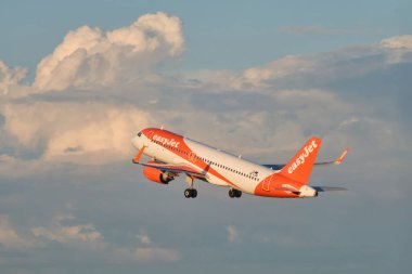 Lisbon, Portugal - September 11, 2023: easyJet Airbus A320-251N passenger plane take off in Humberto Delgado Airport in Lisbon on sunset clipart