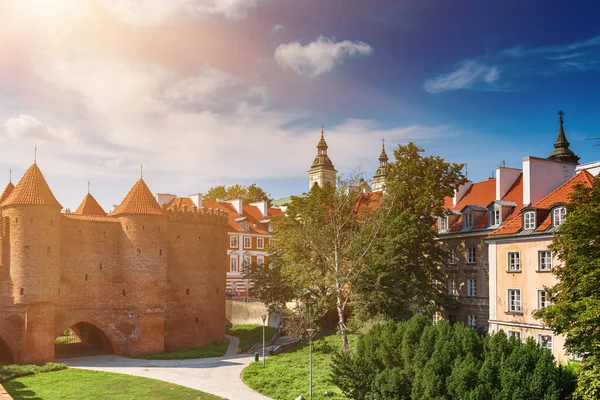 stock image Warsaw, Poland summer view of Barbican or Barbakan wall and old town houses with green trees and blue sky