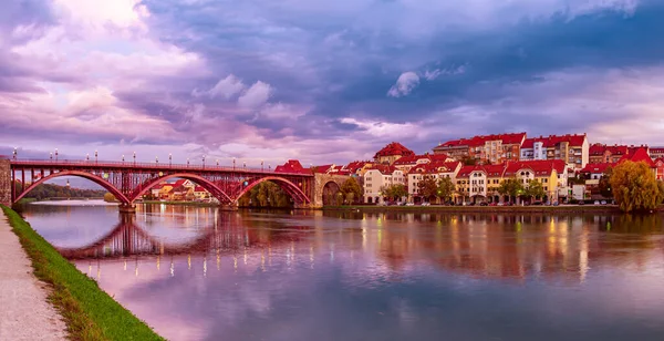 stock image Beautiful view of Maribor city, Slovenia, at sunrise, with river and dramatic sky. Travel outdoor landscape panorama.