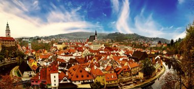 Cesky Krumlov - a famous czech historical beautiful town from above, travel background with red roofs and chapel. Panoramic view.