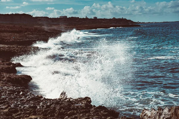 Sea wave splashing on rocks, natural holiday vintage hipster seasonal background. Cyprus