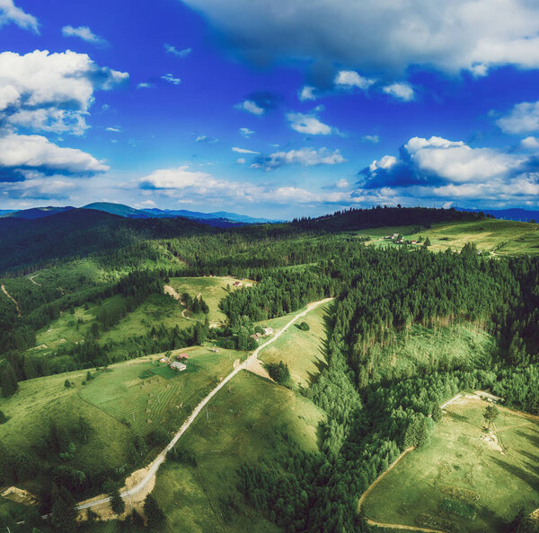 Carpathian mountains summer landscape, seasonal natural background with green hills, blue sky and white clouds