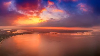 Dramatic colorful sunset over Kyiv sea in Vyshgorod, Ukraine, travel background. Big panorama from drone clipart