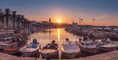 Güneşin doğuşuyla birlikte güzel Split şehrinin panoramik manzarası setle, palmiyelerle, yatlarla ve denizde yüzen teknelerle. Hırvatistan ve Avrupa: Seyahat kavramı.
