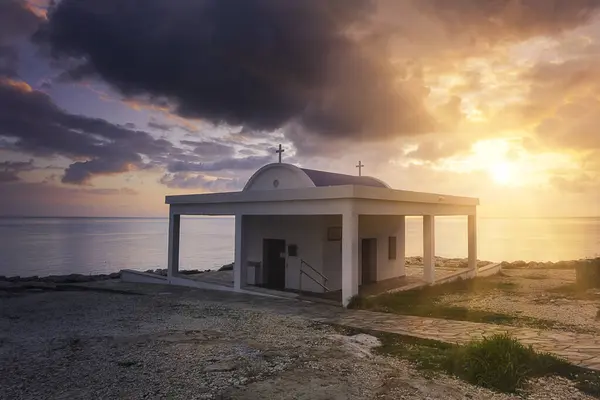 stock image Cyprus, Mediterranean Sea coast. Agioi Anargyroi church at Cape Greco at sunrise, dramatic landscape