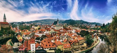 Cesky Krumlov - a famous czech historical beautiful town from above, travel background with red roofs and chapel. Panoramic view.