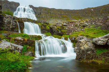 Dynjandi is one the most famous waterfall of the West Fjords during summer, Iceland, amazing view clipart