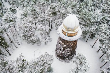 Old observatory tower in the Glen park. Tallinn, Estonia. Winter seasonal landscape. View from above clipart