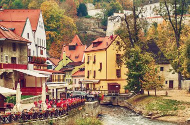 Cesky Krumlov - ünlü bir Czech tarihi güzel kasabası, şehir nehri manzarası ve renkli binalar ve devrilen ağaçlarla dolu güzel bir sonbahar sokağı. Avrupa seyahati geçmişi