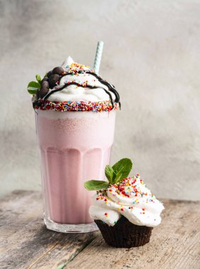 Tahta arka planda muffin ile milkshake..