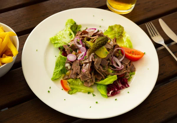 German food name is salad from boiled veal, vegetables and onion