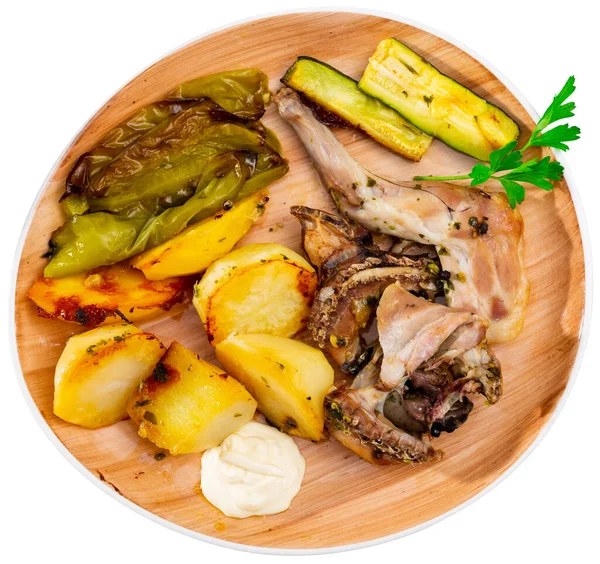 stock image Dietary roasted rabbit served with potato and grilled pepper and zucchini for dinner. Isolated over white background