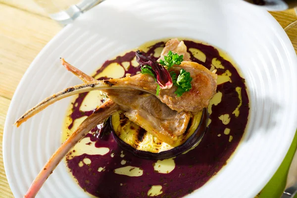 Baked lamb ribs served on grilled aubergine with red wine sauce