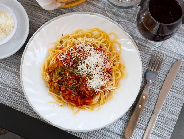 Italian bolonesa, bolognese noodles with tomato sauce and cheese in a cafe