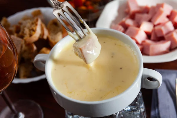 Traditional swiss cheese fondue dinner at a restaurant