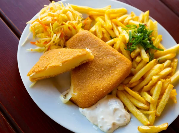 Popular Czech dish of fried cheese served with fries, creamy tartare and vegetables..