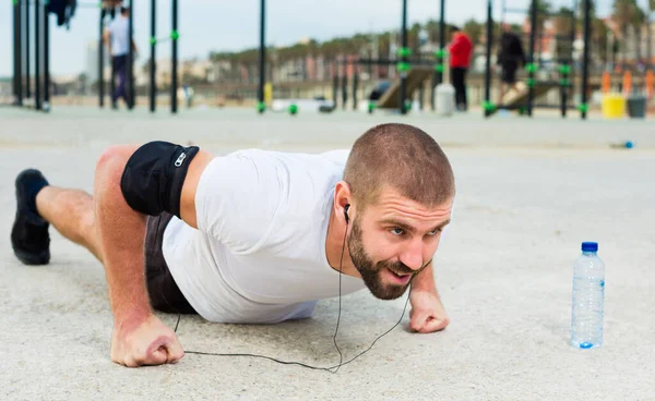 Tense Man Performs Push Ups Outdoor Sports Field — Stock Photo, Image