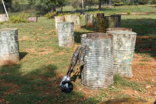 Black Protective Mask Marker Guns Lying Ground Old Barrels Traces — Stock Photo, Image