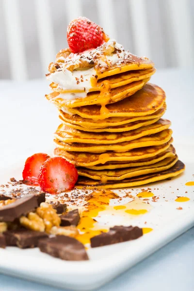 Recipe of sweet pumpkin crepes: grate pumpkin, add eggs, olive oil, salt, spoonful of sugar, milk. Mix and fry in pan without oil. Serve with berries, chocolate, honey, whipped cream.