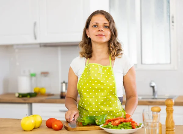 Portrait of young woman food blogger in apron cooking on kitchen