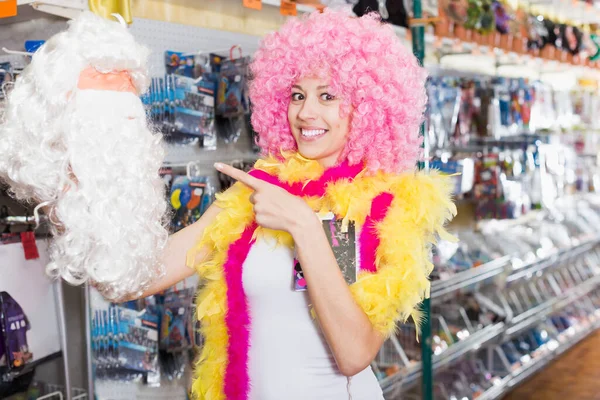 Smiling Woman Selects Funny Wig Store Holiday Accessories — Stock Photo, Image