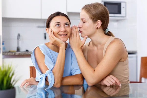 Young Smiling Girlfriends Whispers Ear Sharing Secrets Table — Stock Photo, Image