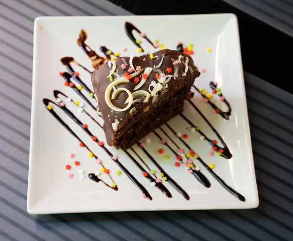 Piece Brownie Cake Plate Some Whipped Cream Chocolate Sauce — Fotografia de Stock