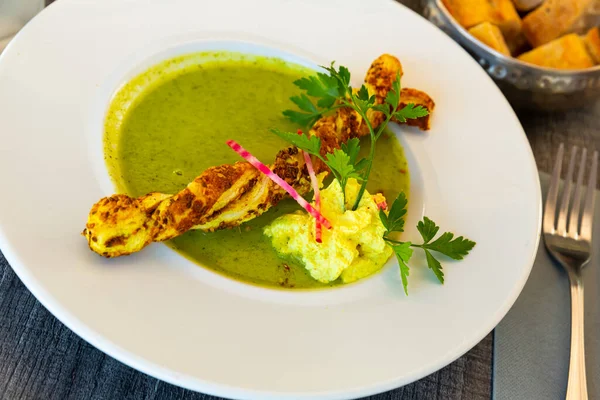 Stock image Vegetable courgette cream soup with breadstick served in white plate