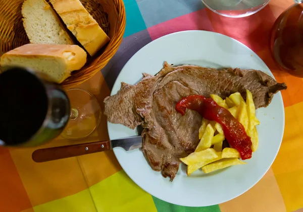 Tasty dinner lamb steak baked in oven served with fried potatoes