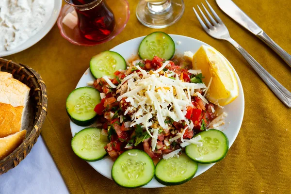 新鮮なガブルダギのサラダの一部は テーブルの上にすりおろしたチーズで提供しています 伝統的なトルコ料理 — ストック写真