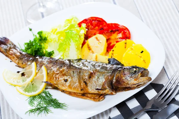 Delicious Baked Trout Served White Plate Potatoes Tomatoes Greens Lemon — Stock Photo, Image