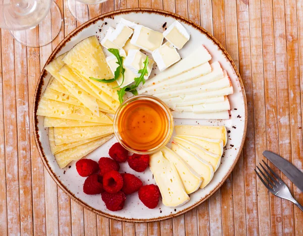 Varieties Cheese Sliced Served Plate Raspberries Honey — Stock Photo, Image