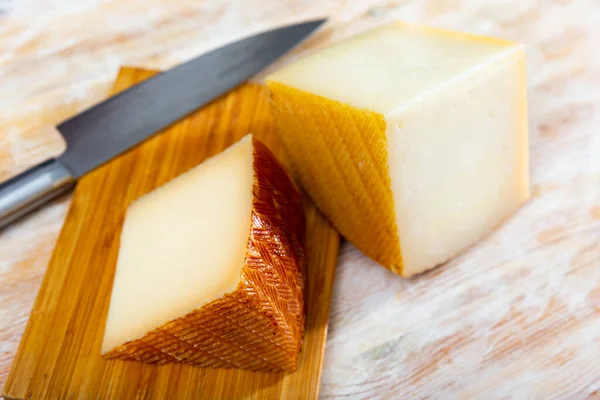 おいしいスライススペイン語半ハードチーズから牛ミルク上の木製テーブル — ストック写真