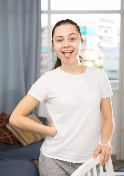 Emotional Young Brunette Woman Posing Camera Home Showing Tongue Out — Stock Photo, Image