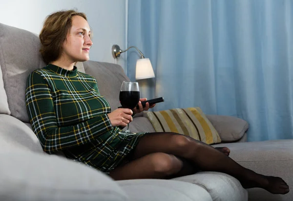 Smiling Young Woman Glass Wine Remote Sitting Couch Home Watching — Stockfoto