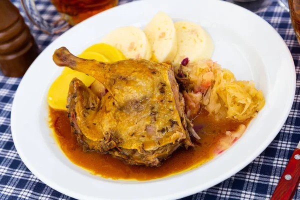 stock image Roasted quarter duck with red and white cabbage, bread and potato dumplings. High quality photo