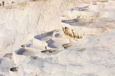 Lacy white travertine formations at hot springs of cotton castle of Pamukkale on sunny day, Turkey clipart