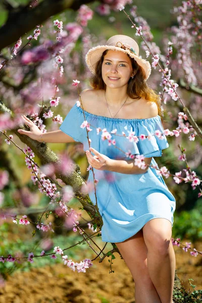 Fiatal Csinos Szalmakalapban Élvezi Természet Tavasszal Gyönyörű Parkban Őszibarack Fák — Stock Fotó