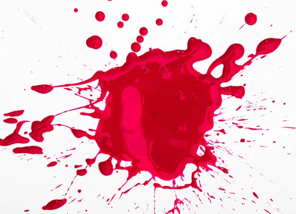 Closeup of shapeless bright red ink blot on white background..