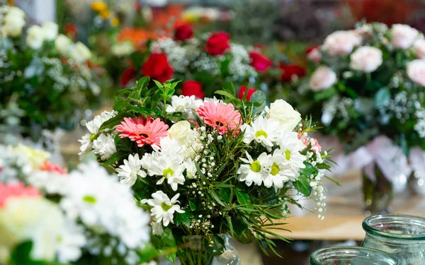 Stylish fresh cut bouquets of different beauty flowers at flower shop