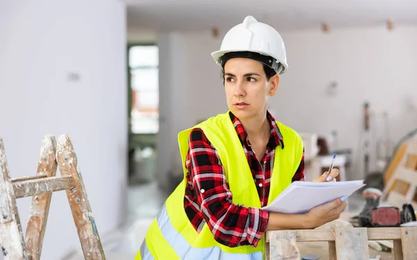 Portrait Excited Young Woman Builder Next Stepladder Documents Her Hands — Stock Photo, Image
