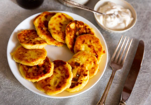 stock image Belarusian, Russian, Ukrainian national dish syrniki cooked and served on white circular plate.