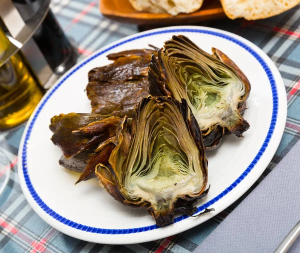 stock image Delicious fried artichoke halves on a white plate