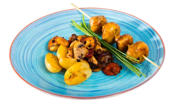 Stock image Tasty mix of roasted mushrooms with baked potatoes decorated with chives. Isolated over white background