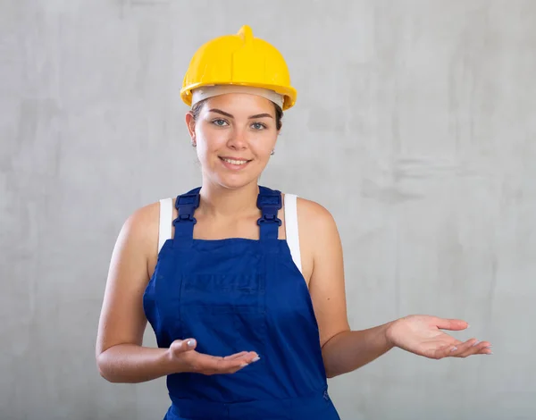 Cheerful Female Worker Overalls Hardhat Showing Something — Stock Photo, Image