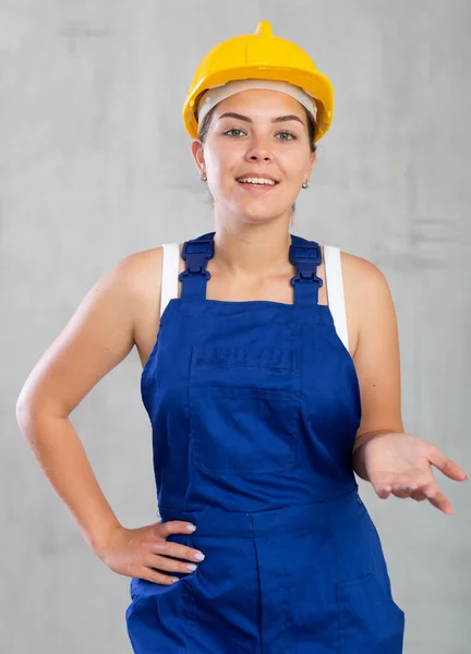 Cheerful Female Worker Overalls Hardhat Showing Something — Stock Photo, Image