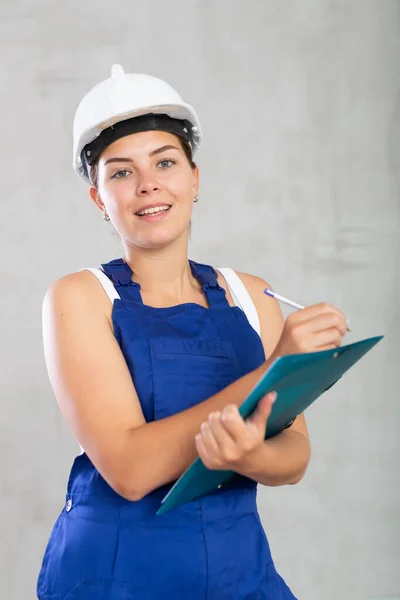 Portrait Young Worker Woman Overalls Making Notes Folder Studio — Stock Photo, Image
