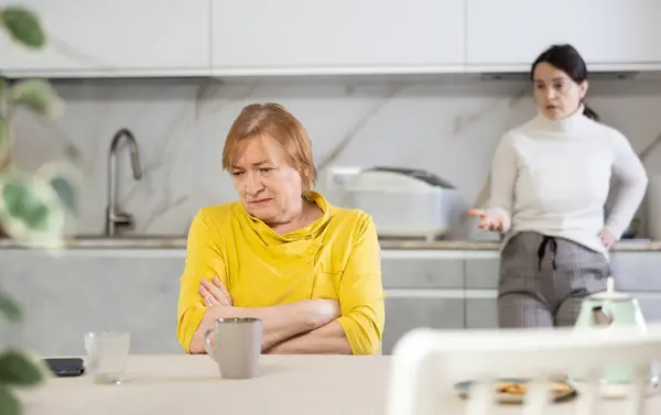 Distressed Mature Woman Conflict Her Daughter Sitting Table Home Kitchen Royalty Free Stock Images
