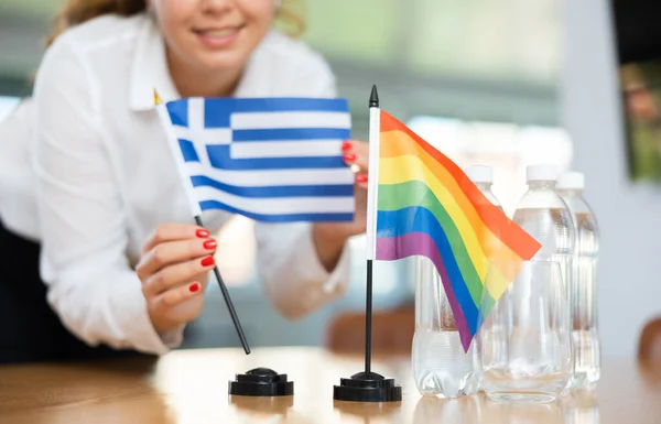 Young Woman Business Clothes Puts Flags Greece Lgbt Negotiating Table — Stock Photo, Image